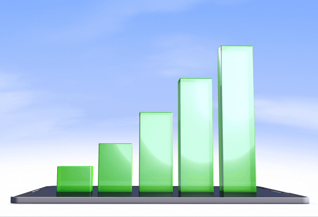 A series of rising green bars sit on a cell phone, before a bright blue sky.