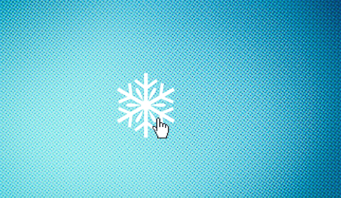 An image of a white snowflake sits on a blue computer screen with a little hand-shaped cursor about to click on it.