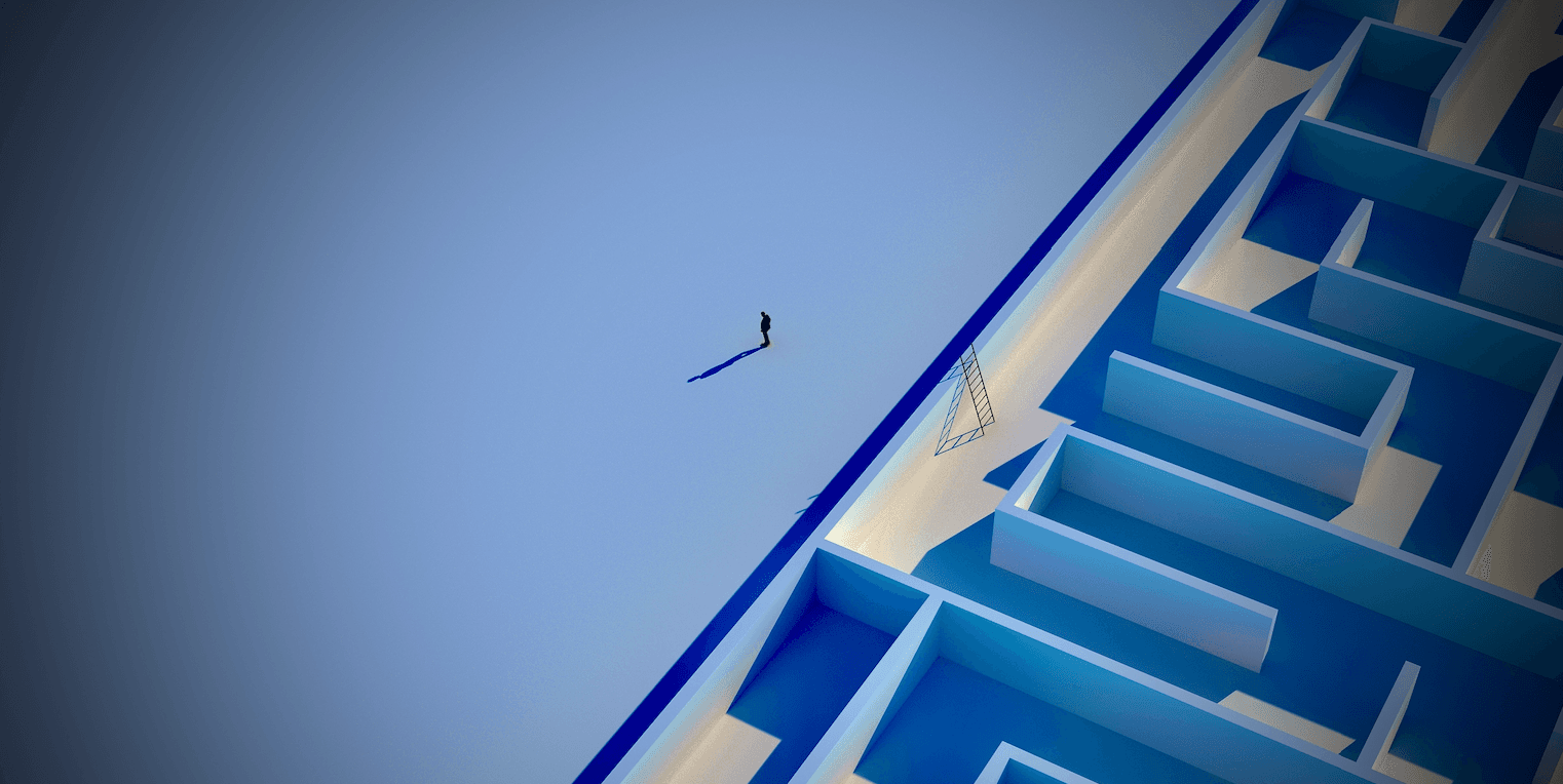 An image, seen from high above, of a businessman standing near a ladder that leans against the wall of a large maze.